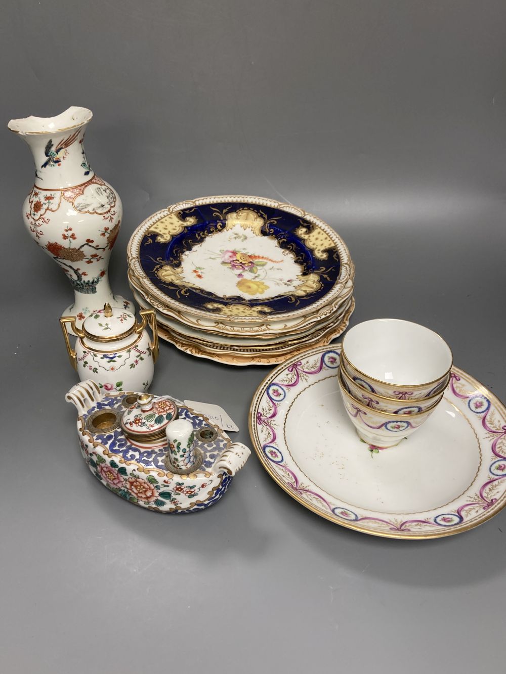 A Worcester Kakiemon vase, c.1765, a 19th century Paris porcelain plate and three tea bowls and 19th century English porcelain plates e